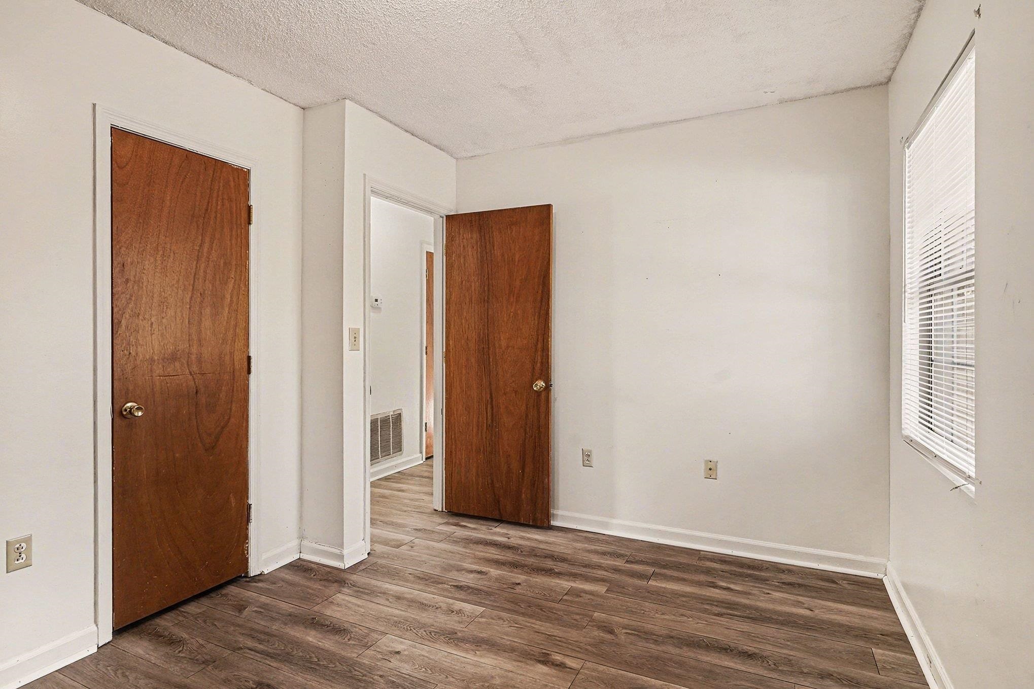 916 Brinkley Street Georgetown, SC 29440 - Photo 21 of 39 Unfurnished bedroom featuring dark wood-style flooring and a textured ceiling