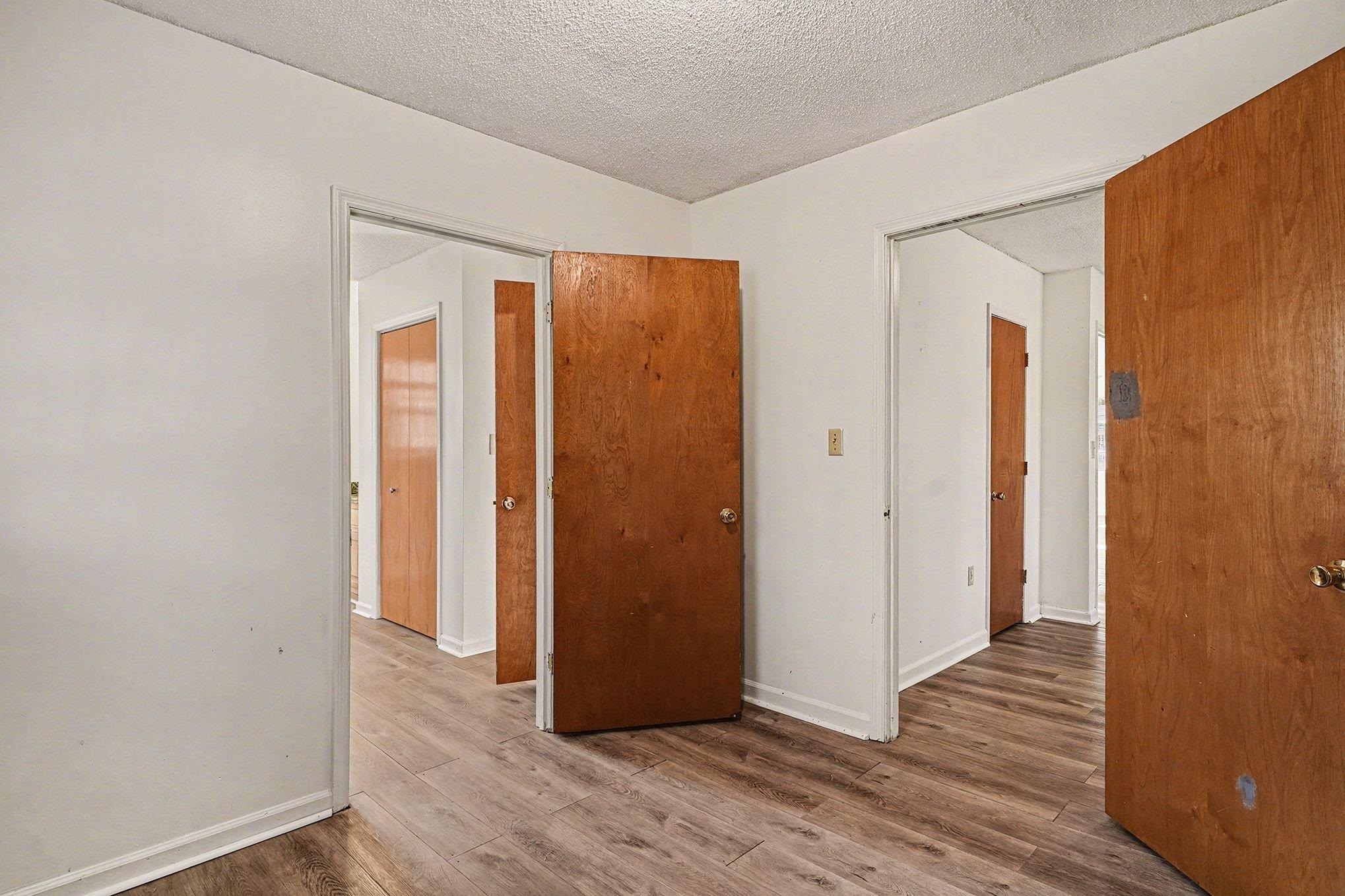 916 Brinkley Street Georgetown, SC 29440 - Photo 23 of 39 Unfurnished room with wood finished floors and a textured ceiling