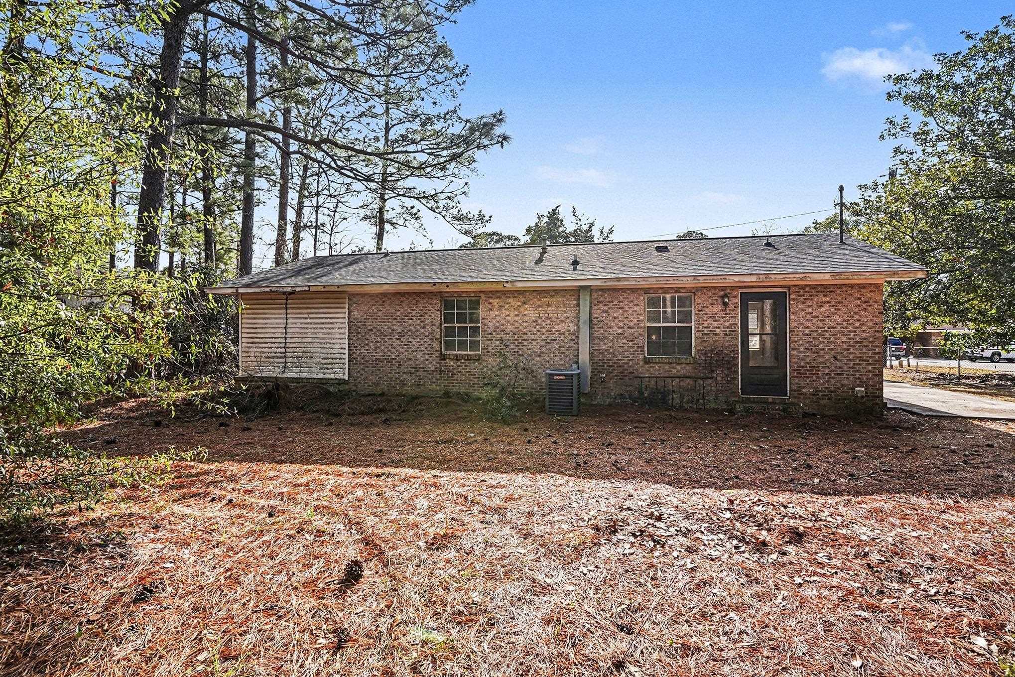 916 Brinkley Street Georgetown, SC 29440 - Photo 26 of 39 Rear view of house featuring brick siding and roof with shingles