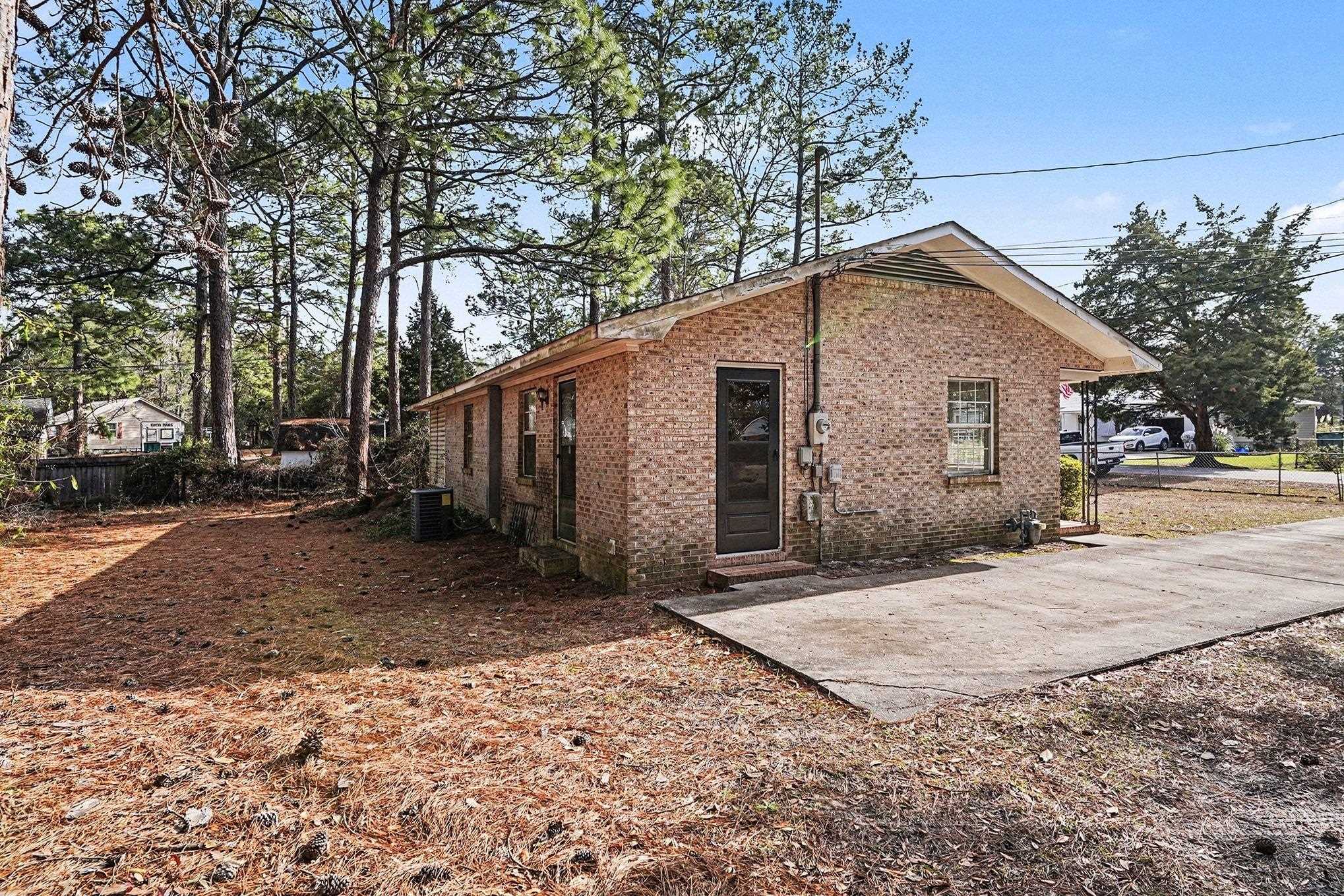 916 Brinkley Street Georgetown, SC 29440 - Photo 28 of 39 View of side of property featuring brick siding and a patio area