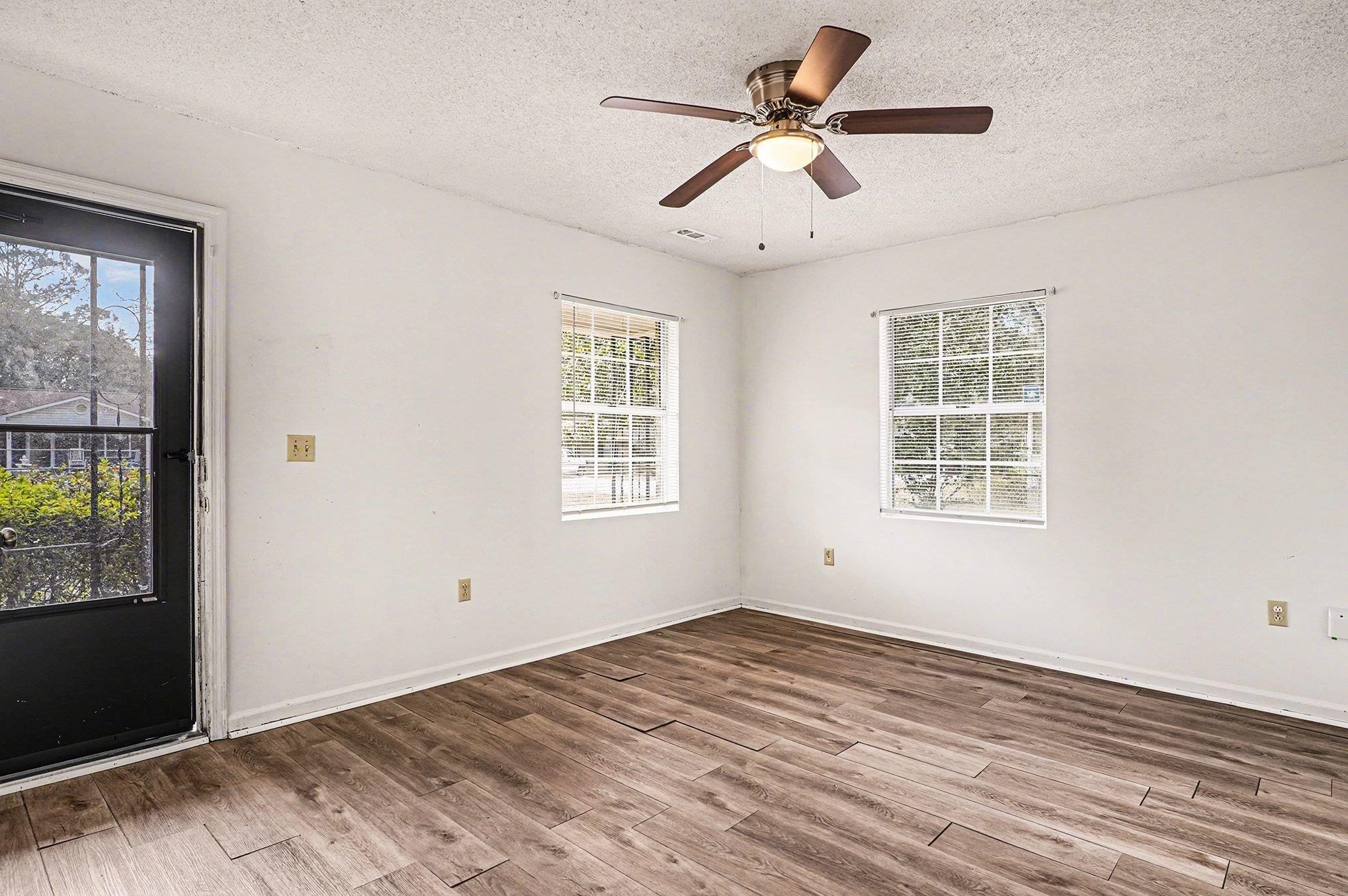 916 Brinkley Street Georgetown, SC 29440 - Photo 5 of 39 Empty room featuring wood finished floors, a textured ceiling, and ceiling fan