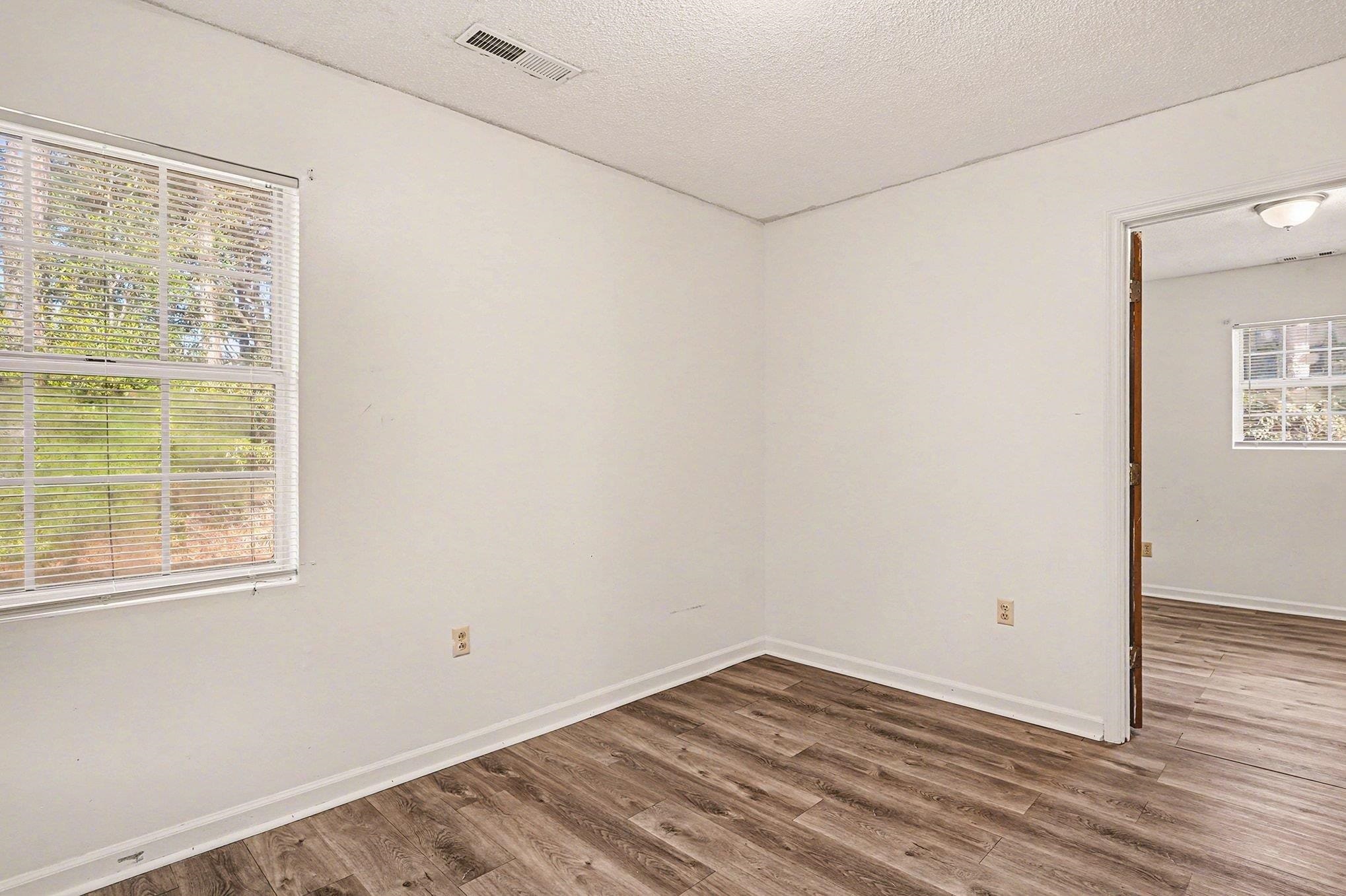 916 Brinkley Street Georgetown, SC 29440 - Photo 6 of 39 Empty room with wood finished floors and a textured ceiling