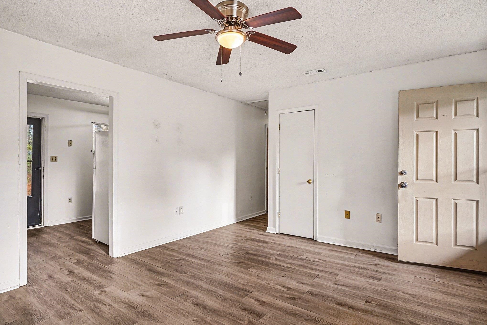 916 Brinkley Street Georgetown, SC 29440 - Photo 7 of 39 Unfurnished bedroom with wood finished floors, a textured ceiling, and ceiling fan
