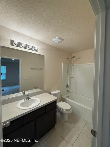 a bathroom with a sink a toilet a shower and a mirror