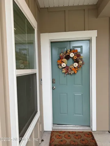a view of a entryway door of the room