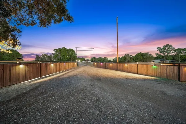 a view of a road next to a yard