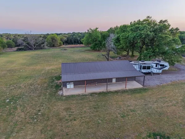 a wooden bench sitting in the middle of a yard