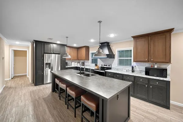 a kitchen with stainless steel appliances a sink stove and refrigerator
