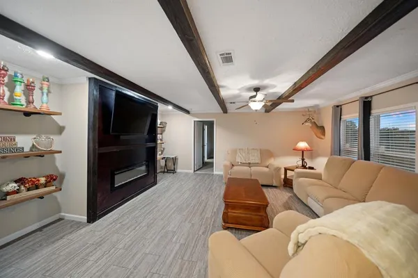 a living room with furniture flat screen tv and a fireplace
