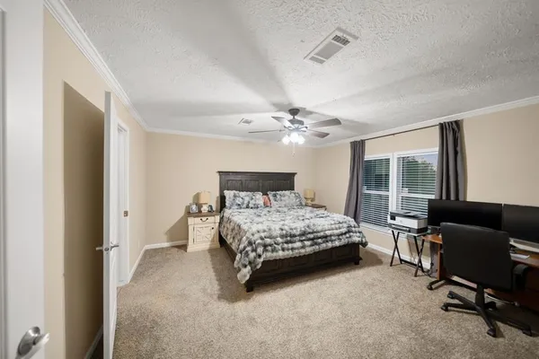 a bedroom with a bed and a chair