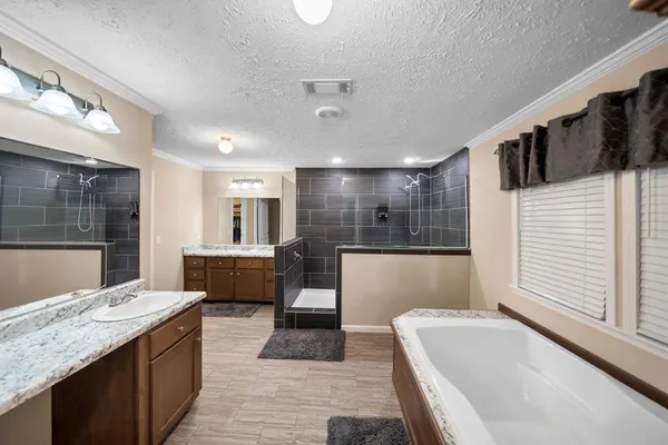 a large bathroom with a large tub and sink