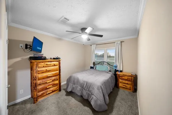 a bedroom with a bed and a chandelier
