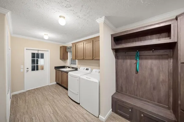 a kitchen with a refrigerator and white cabinets