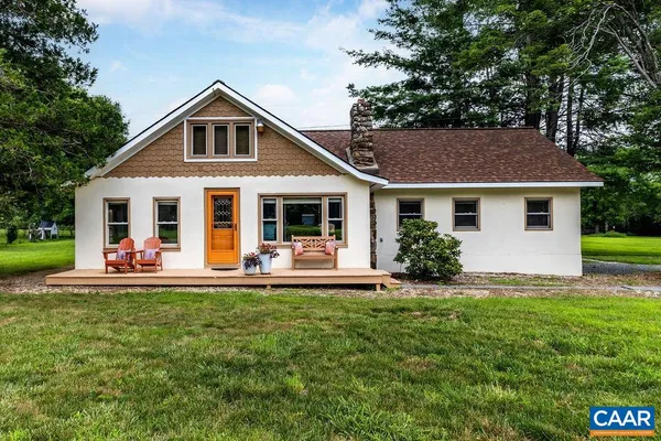 a front view of a house with a yard and porch