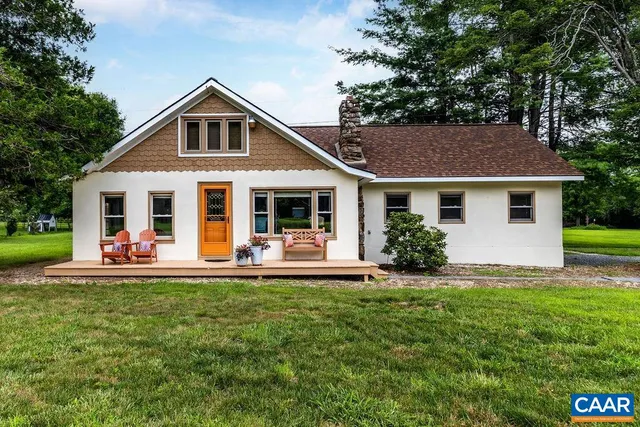 a front view of a house with a yard and porch