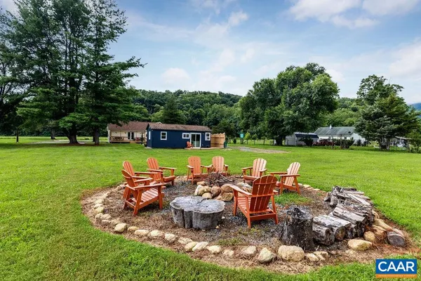 a view of outdoor space with chairs and wooden fence