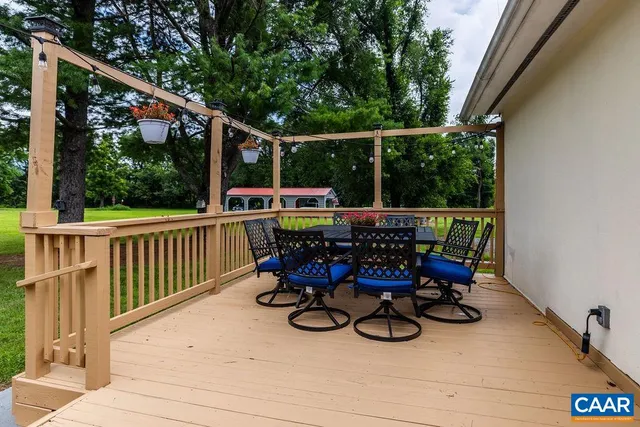 a view of a deck with chairs a barbeque grill with wooden fence