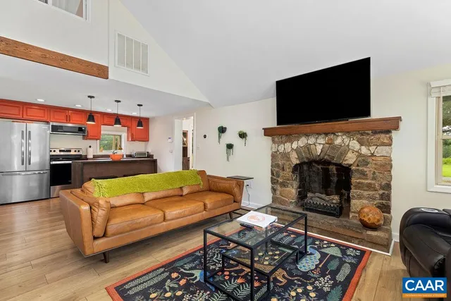 a living room with furniture a fireplace and a flat screen tv