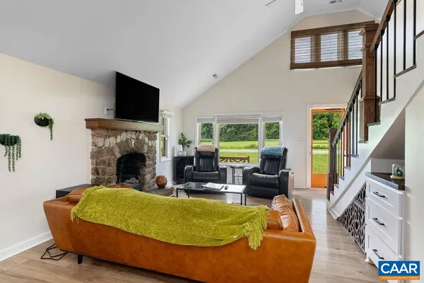 a living room with furniture a flat screen tv and a fireplace