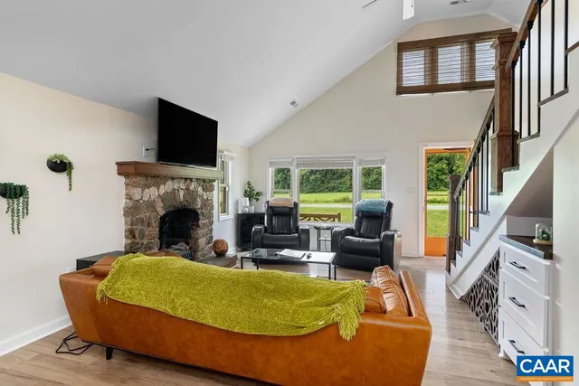a living room with furniture a flat screen tv and a fireplace