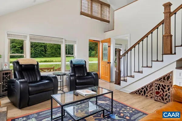 a kitchen with stainless steel appliances granite countertop a refrigerator a sink dishwasher a stove and a dining table with wooden floor