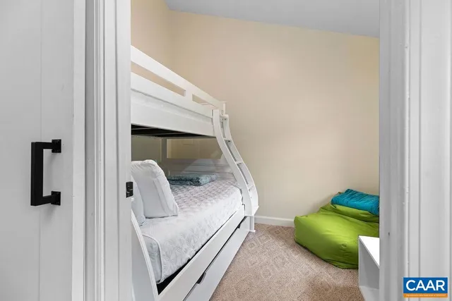 a bedroom with a bed and painting on the wall