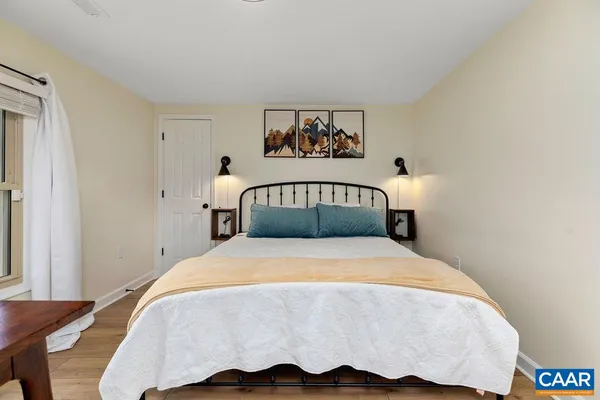 a bedroom with a bed and a night stand