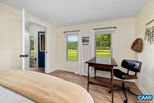 a dining room with furniture and a window
