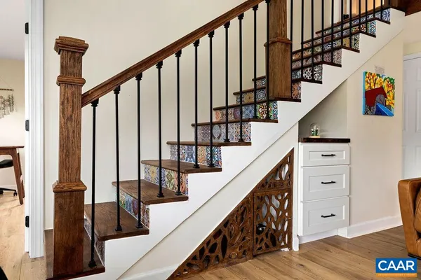 a view of a workspace with furniture and a window