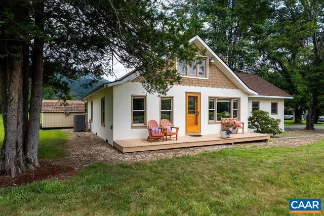 a front view of house with yard and outdoor seating