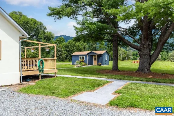 a view of a house with a yard and sitting area