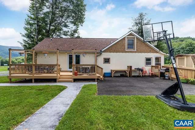 a view of a house with a yard and sitting area