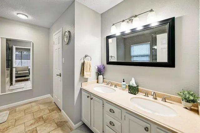 a bathroom with a sink vanity and mirror
