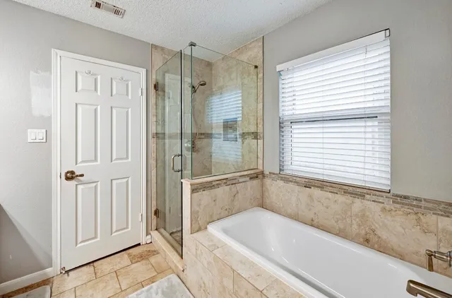 a bathroom with a bathtub and a shower
