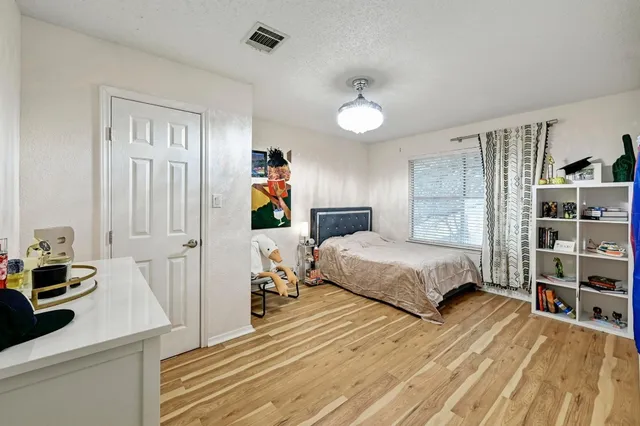 a bedroom with a bed and a book shelf