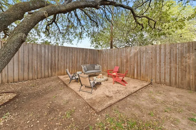 a view of backyard with a table and chairs