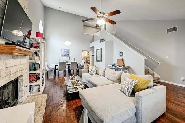 a living room with furniture a fireplace and a flat screen tv
