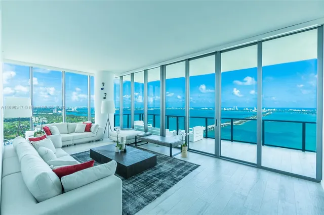 a living room with furniture city view and large windows