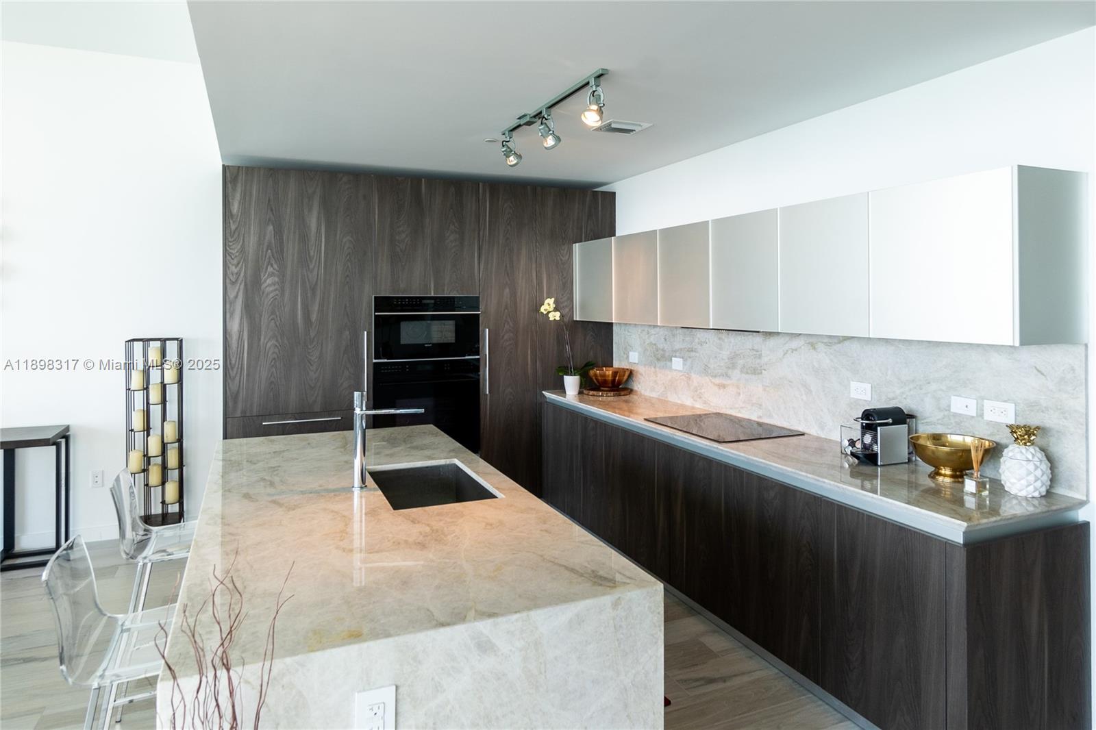 3131 Northeast 7th Avenue, Unit PH4903 Miami, FL 33137 - Photo 6 of 33 a kitchen that has a sink and a stove in it