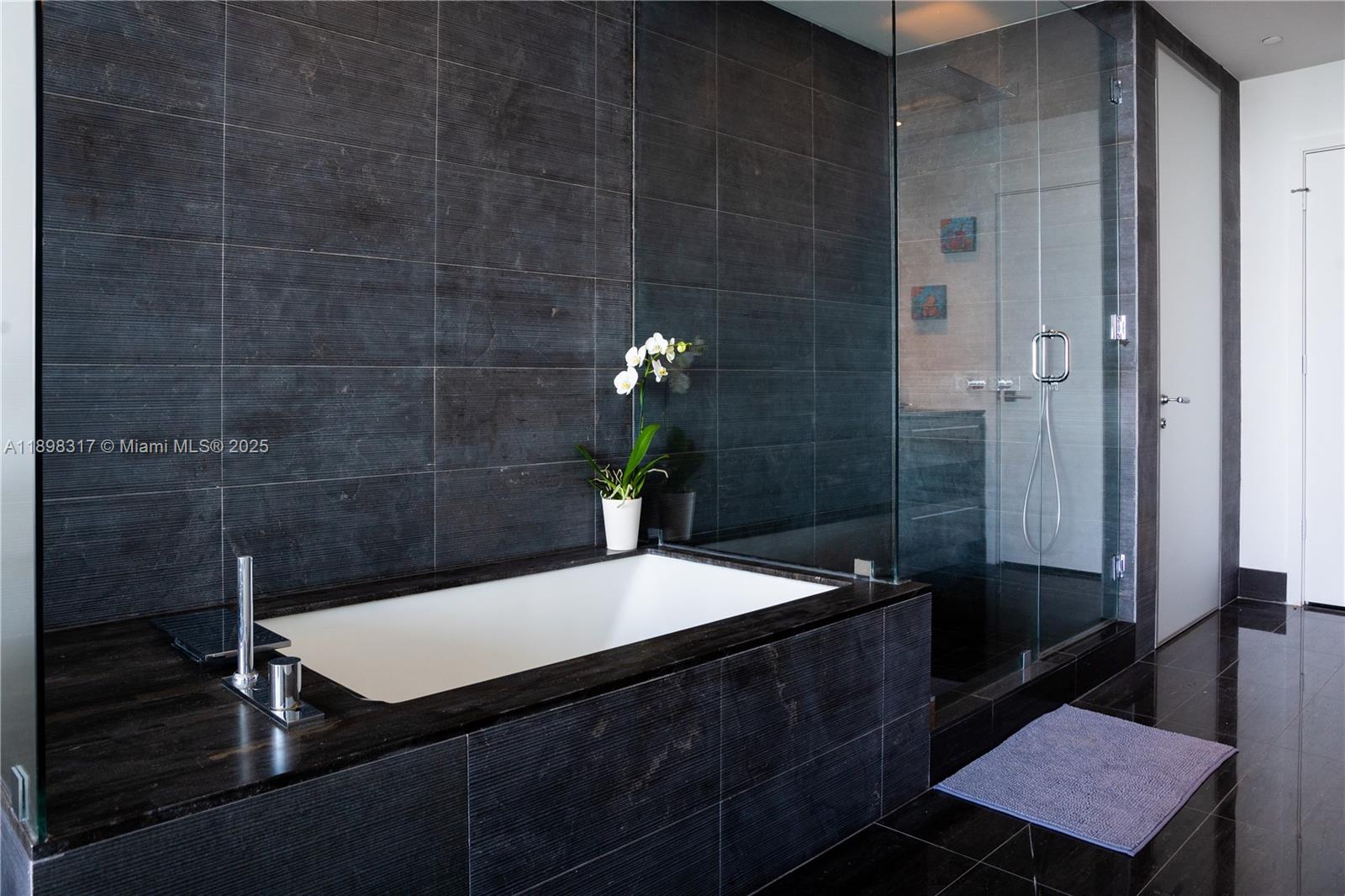 3131 Northeast 7th Avenue, Unit PH4903 Miami, FL 33137 - Photo 8 of 33 a bathroom with a sink and a mirror