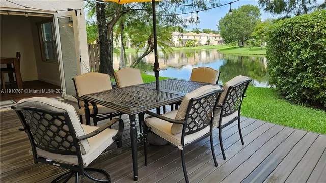 a backyard of a house with table and chairs