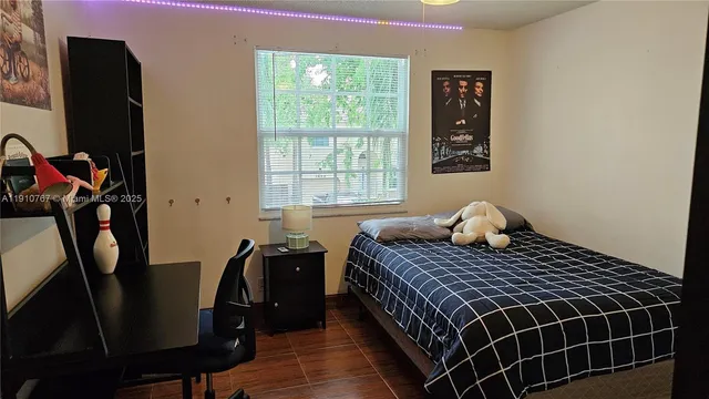 a bedroom with a bed and window