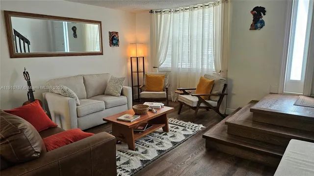 a living room with furniture and a rug