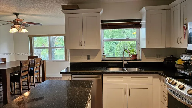 a kitchen with a window a sink and cabinets