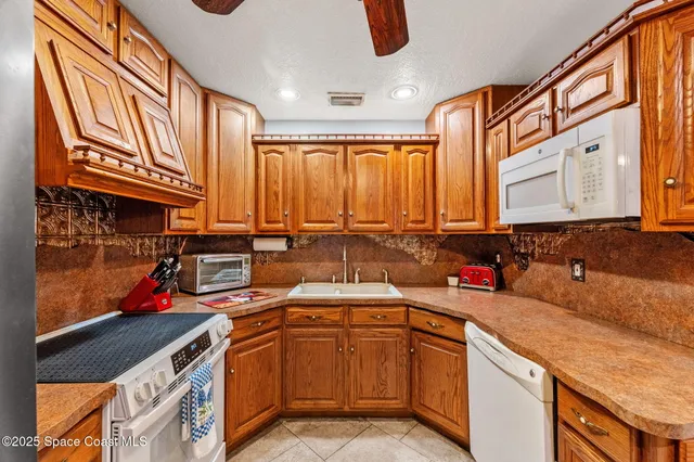 a living room with furniture a fireplace and a chandelier