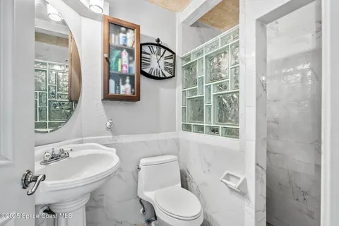 a view of a swimming pool with a patio and a yard