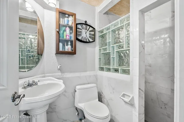 a view of a swimming pool with a patio and a yard