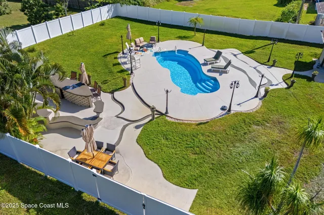 a view of a swimming pool with potted plants