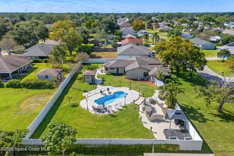 an aerial view of a house with a garden