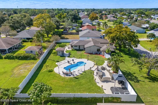 an aerial view of a house with a garden